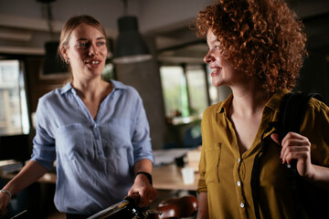 Colleagues working in the office. Two girlfriends working together.
