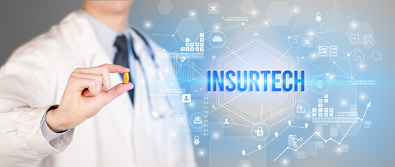 Doctor giving a pill with INSURTECH inscription, new technology solution concept