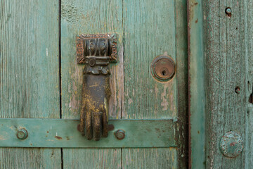 Old door knocker with hand figure