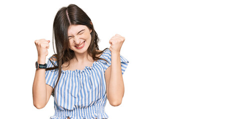 Young beautiful caucasian girl wearing casual clothes excited for success with arms raised and eyes closed celebrating victory smiling. winner concept.