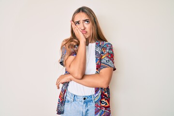 Young beautiful blonde woman wearing modern clothes thinking looking tired and bored with...
