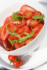 Close  - up of sliced tomatoes with rucola