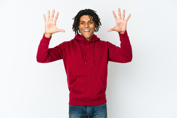 Young african american rasta man receiving a pleasant surprise, excited and raising hands.