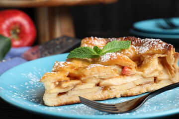 Slice of traditional apple pie on plate, closeup