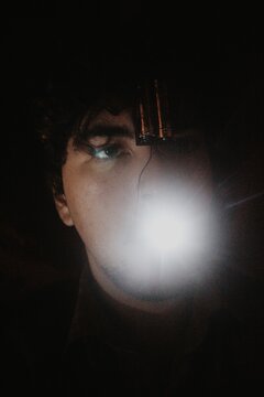 Glowing person with electric in the darkness, an abstract art portrait, tongue to confess