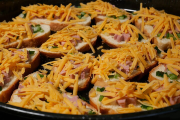 Many homemade sandwiches on the metal deck before cooking