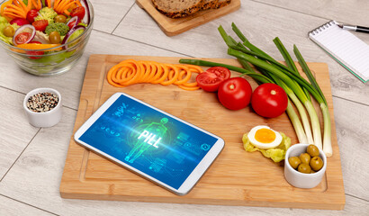 PILL concept in tablet with fruits, top view