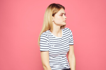 Fototapeta premium Woman in striped t-shirt emotions studio cropped view lifestyle pink isolated background