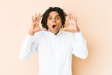 Young african american rasta man surprised and shocked.