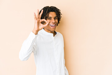 Young african american rasta man cheerful and confident showing ok gesture.