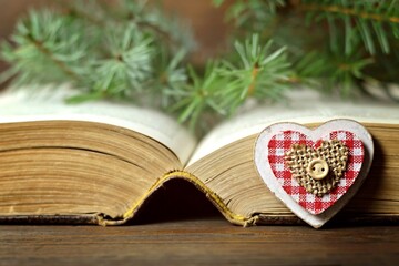 Wooden Christmas heart ornament and old book