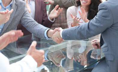 business people shaking hands sitting at the office Desk