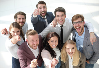happy team of successful young business people pointing at you