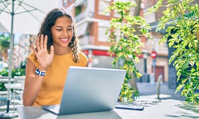 Young african american student girl doing video call using laptop.