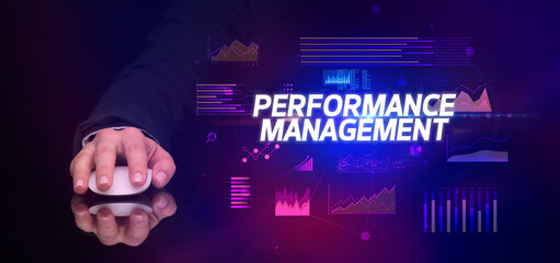 hand holding wireless peripheral with PERFORMANCE MANAGEMENT inscription, cyber business concept