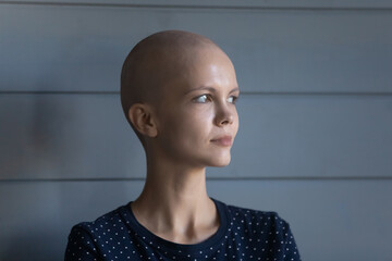 Facing off against cancer. Concentrated strong young hairless female diagnosed with oncology posing...