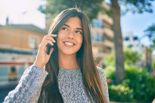 Young beautiful hispanic girl smiling happy talking on the smartphone at the city.