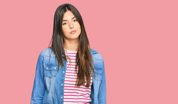 Young brunette woman wearing casual clothes looking sleepy and tired, exhausted for fatigue and hangover, lazy eyes in the morning.