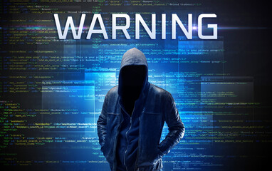 Faceless hacker with WARNING inscription on a binary code background