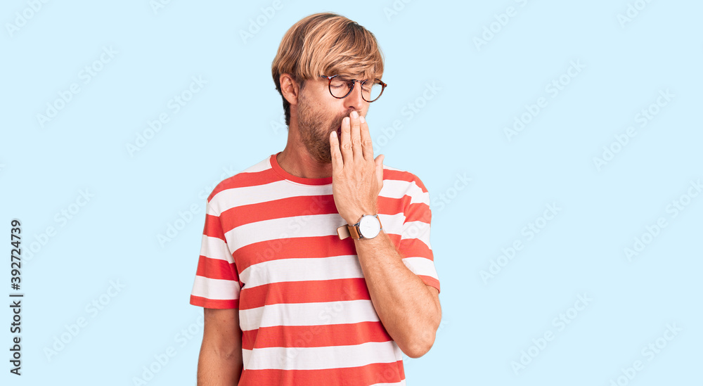 Canvas Prints Handsome caucasian man with beard wearing casual clothes and glasses bored yawning tired covering mouth with hand. restless and sleepiness.