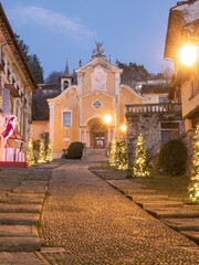 Christmas trees in the ancient cobbled street leading to the church of Orta San Giulio, a beautiful medieval village in Piedmont.Italy