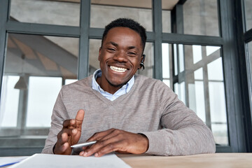 Cheerful african business man talking to web cam on conference call. Happy black businessman,...