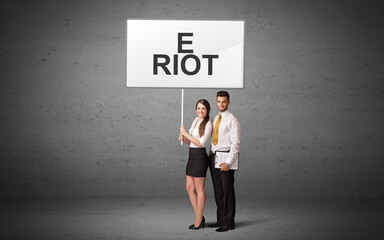 business person holding a traffic sign with E RIOT inscription, new idea concept