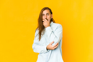 Young man with long hair look scared and afraid.