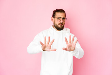 Young man with long hair look rejecting someone showing a gesture of disgust.