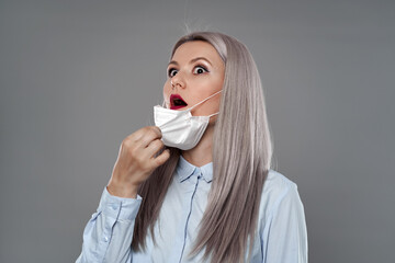 Woman pulling her mask and gasping for air