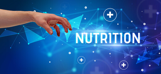 Close-Up of cropped hand pointing at NUTRITION inscription, medical concept
