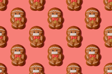 Christmas gingerbread man in medicine mask on the rose background. Seamless pattern