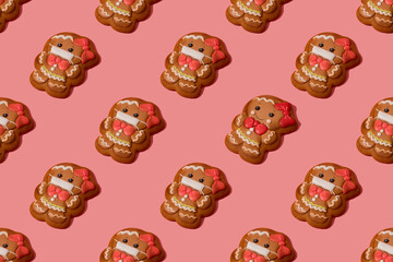 Christmas gingerbread girl without medicine mask among other gingerbread girl in medicine mask on the rose background. Be responsible. Seamless pattern