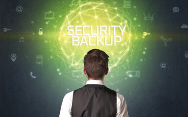 Rear view of a businessman with SECURITY BACKUP inscription, online security concept