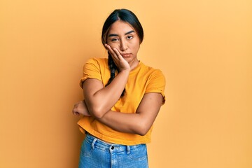 Young latin woman wearing casual clothes thinking looking tired and bored with depression problems with crossed arms.