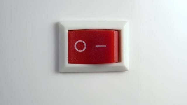 Red switch off. Pressing the button to turn off the device. Macro shot. Close up