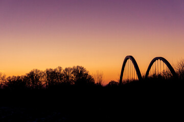 Fototapeta na wymiar Landscape silhouette with bridge of munsterland at dusk