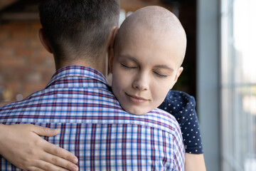 Your love and support means so much to me... Close up shot of affectionate millennial woman fighting against oncology cuddling tender caring husband, leaning head on his shoulder with gratitude trust