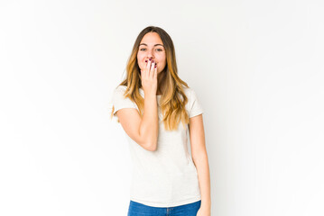 Young caucasian woman isolated on white background shocked, covering mouth with hands, anxious to discover something new.