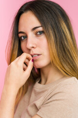 Young beautiful woman isolated on pink background