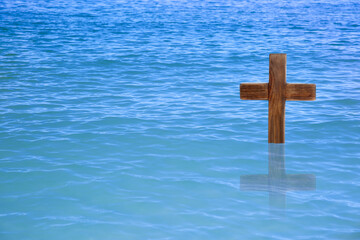 Wooden cross in river for religious ritual known as baptism