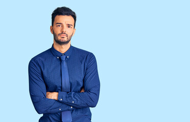 Young handsome hispanic man wearing business clothes skeptic and nervous, disapproving expression...