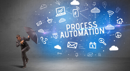 Businessman defending with umbrella from PROCESS AUTOMATION inscription, modern technology concept