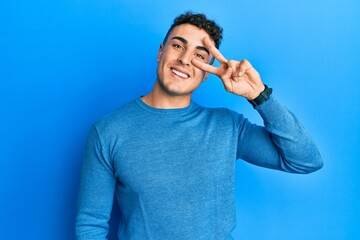 Handsome young man wearing casual clothes smiling swearing with hand on chest and fingers up,...