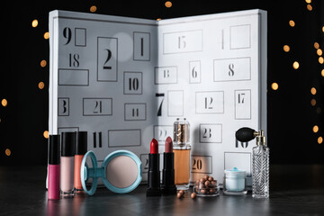 Christmas advent calendar with perfumes, skin care and decorative cosmetics on table