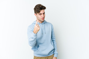 Young caucasian man isolated on white background pointing with finger at you as if inviting come closer.