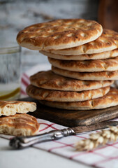 
Fresh tortillas stacked on wooden table