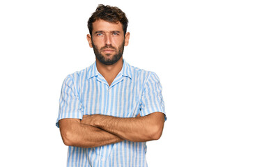 Fototapeta premium Handsome young man with beard wearing casual fresh shirt skeptic and nervous, disapproving expression on face with crossed arms. negative person.
