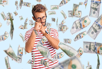 Handsome blond man with beard wearing casual clothes and glasses ready to fight with fist defense...