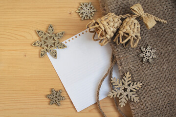 Snowflakes and bells on a wooden surface. Christmas decorations